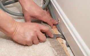 Handy Man Installing Carpet - Flooring Installation